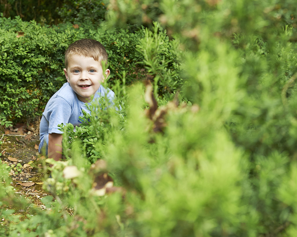 portrait of a boy playing in nature